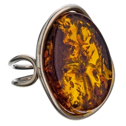 A beautiful honey amber cabochon framed in a classic sterling silver frame. Size is approx 1.25" x 1". Adjustable one time between size 6 to 9.