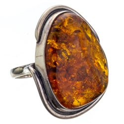 A beautiful amber cabochon framed in a classic sterling silver frame. Size is approx 1.25" x 1".