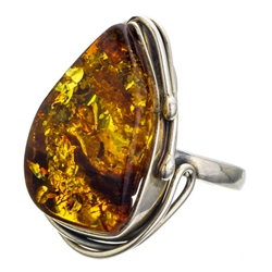 A beautiful amber cabochon framed in a classic sterling silver frame. Size is approx 1.25" x .75".