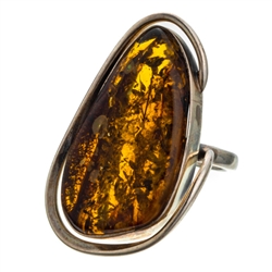 A beautiful amber cabochon framed in a classic sterling silver frame. Size is approx 1.5" x .8".