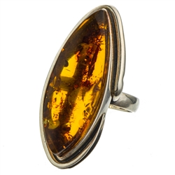 A beautiful amber cabochon framed in a classic sterling silver frame. Size is approx 1.75" x .75".