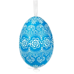 This beautifully designed egg is dyed one color, then white wax is melted and applied to form an intricate design which is left on the surfce. The egg is emptied and strung with ribbon for hanging.