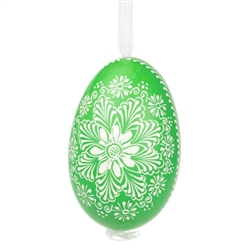 This beautifully designed egg is dyed one color, then white wax is melted and applied to form an intricate design which is left on the surfce. The egg is emptied and strung with ribbon for hanging.