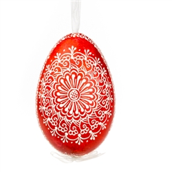 This beautifully designed egg is dyed one color, then white wax is melted and applied to form an intricate design which is left on the surfce. The egg is emptied and strung with ribbon for hanging.