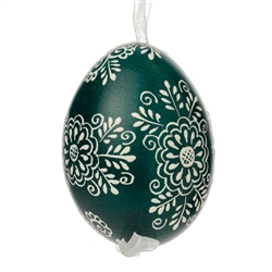 This beautifully designed egg is dyed one color, then white wax is melted and applied to form an intricate design which is left on the surfce. The egg is emptied and strung with ribbon for hanging.