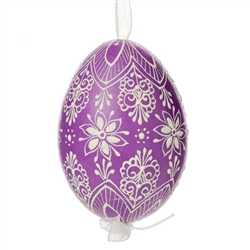 This beautifully designed egg is dyed one color, then white wax is melted and applied to form an intricate design which is left on the surfce. The egg is emptied and strung with ribbon for hanging.