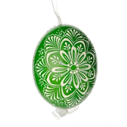 This beautifully designed egg is dyed one color, then white wax is melted and applied to form an intricate design which is left on the surfce. The egg is emptied and strung with ribbon for hanging.