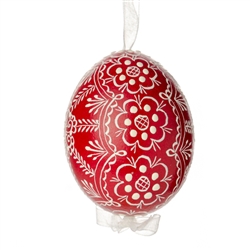 This beautifully designed egg is dyed one color, then white wax is melted and applied to form an intricate design which is left on the surfce. The egg is emptied and strung with ribbon for hanging.