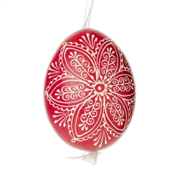 This beautifully designed egg is dyed one color, then white wax is melted and applied to form an intricate design which is left on the surfce. The egg is emptied and strung with ribbon for hanging.