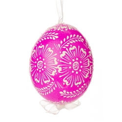 This beautifully designed egg is dyed one color, then white wax is melted and applied to form an intricate design which is left on the surfce. The egg is emptied and strung with ribbon for hanging.