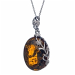 A beautiful honey amber cabochon framed in an open back sterling silver frame. Pendant size is approx. 1.1" x .9".