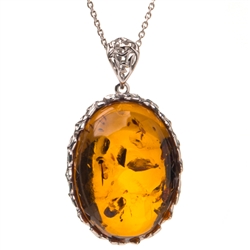 Beautiful amber cabochon surrounded by a sterling silver frame on an adjustable length chain.  Pendant size is approx. 1.25" x 1".