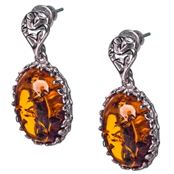 Gorgeous Baltic Amber earrings surrounded with a ring of Sterling Silver filigree work. Approx 1.2" long x .5" wide.