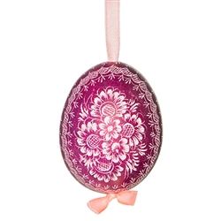 This beautifully designed chicken egg is dyed one color and the design scratched into the egg using a sharp knife. The technique is called "skrobanki" in Polish. The eggs have been emptied and strung through with ribbon for hanging. No two eggs are exactl