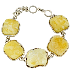 Classic custard amber cabochons set in a sterling silver frames. 8.25" long.  The amber is approx .75 square and total weight is 34g.