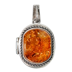 Beautiful honey amber pendant set in sterling silver opens to reveal a locket.  Size is approx 1.5' x 1" (closed).