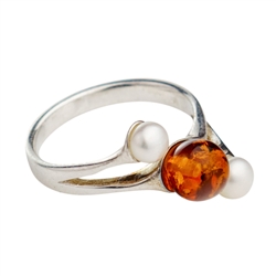 Stylish and delicate sterling silver ring with amber and pearl. Amber is very soft and in this setting must be treated with care.  Ring should be removed before washing your hand.
&#8203;