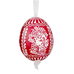 This beautifully designed egg is dyed one color, then white wax is melted and applied to form an intricate design which is left on the surfce. The egg is emptied and strung with ribbon for hanging.