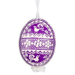 This beautifully designed egg is dyed one color, then white wax is melted and applied to form an intricate design which is left on the surfce. The egg is emptied and strung with ribbon for hanging.