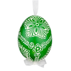 This beautifully designed egg is dyed one color, then white wax is melted and applied to form an intricate design which is left on the surfce. The egg is emptied and strung with ribbon for hanging.