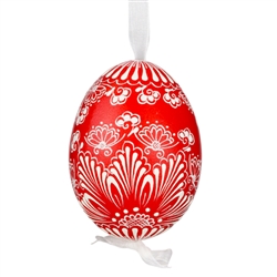 This beautifully designed egg is dyed one color, then white wax is melted and applied to form an intricate design which is left on the surfce. The egg is emptied and strung with ribbon for hanging.