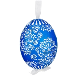 This beautifully designed egg is dyed one color, then white wax is melted and applied to form an intricate design which is left on the surfce. The egg is emptied and strung with ribbon for hanging.