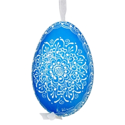 This beautifully designed egg is dyed one color, then white wax is melted and applied to form an intricate design which is left on the surfce. The egg is emptied and strung with ribbon for hanging.