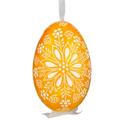 This beautifully designed egg is dyed one color, then white wax is melted and applied to form an intricate design which is left on the surfce. The egg is emptied and strung with ribbon for hanging.