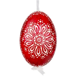 This beautifully designed egg is dyed one color, then white wax is melted and applied to form an intricate design which is left on the surfce. The egg is emptied and strung with ribbon for hanging.