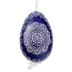 This beautifully designed egg is dyed one color, then white wax is melted and applied to form an intricate design which is left on the surfce. The egg is emptied and strung with ribbon for hanging.