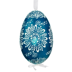 This beautifully designed egg is dyed one color, then white wax is melted and applied to form an intricate design which is left on the surfce. The egg is emptied and strung with ribbon for hanging.