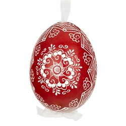 This beautifully designed egg is dyed one color, then white wax is melted and applied to form an intricate design which is left on the surfce. The egg is emptied and strung with ribbon for hanging.