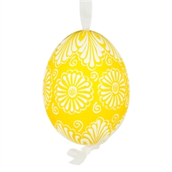 This beautifully designed egg is dyed one color, then white wax is melted and applied to form an intricate design which is left on the surfce. The egg is emptied and strung with ribbon for hanging.