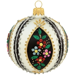 A garden of brilliant blooms merge with bold, vertical stripes in this dazzling and sophisticated design. Accented with glistening gold glazes and a wealth of colorful glitter, our black and white glass ornament with flowers will be a striking addition to