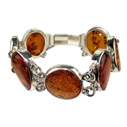 This sterling silver bracelet features 7 honey color amber cabochons. Bracelet size is 7.25" diameter. Cabochon sizes are approx .9" x .6"