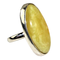 A beautiful custard color amber cabochon framed in a classic sterling silver frame. Size is approx 1.25" x .75".