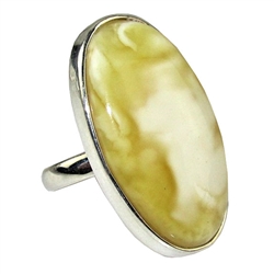 A beautiful custard color amber cabochon framed in a classic sterling silver frame. Size is approx 1.25 x .75".