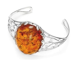 Artistic sterling silver cuff bracelet features a beautiful large amber cabochon (approx 1.5" x 1.25' x .5).