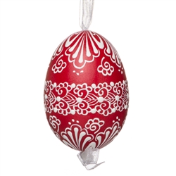 This beautifully designed egg is dyed one color, then white wax is melted and applied to form an intricate design which is left on the surfce. The egg is emptied and strung with ribbon for hanging.