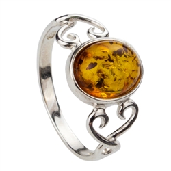 An oval of honey Baltic amber set between Sterling Silver Celtic hearts