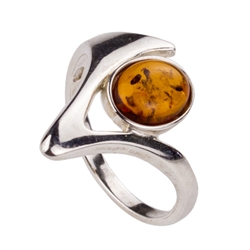 An oval of honey amber set in an artistic swirl of sterling silver.