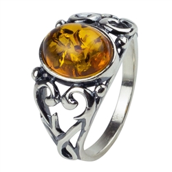 An oval of honey amber set in an artistic swirl of sterling silver.