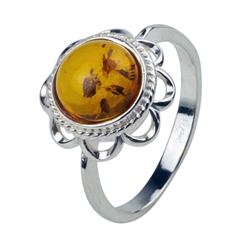 An oval of honey amber set in an artistic swirl of sterling silver.