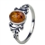 An oval of honey amber set in an artistic swirl of sterling silver.