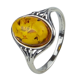 An oval of honey amber set in an artistic setting of sterling silver.  Amber size is 0.4" x 0.5"
