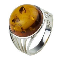 A nice honey amber cabochon set in an artistic swirl of sterling silver.  Amber is approx 0.6" diameter