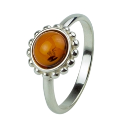 Honey amber set in a classic sterling silver setting.  The center piece is approx 0.4" diameter.