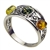 Artistic sterling silver ring highlighting three amber cabochons. Ring is about 0.4" wide.