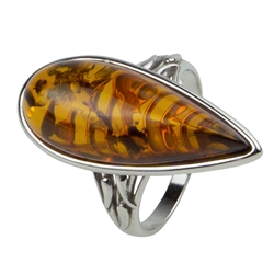 Modern design amber and sterling silver ring. The amber size is approx. 1" x 0.5"