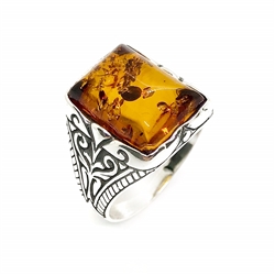 Rectangle shaped amber stone set in .925 sterling silver. Genuine Baltic amber. Front size is approx. 0.5" x 0.65".